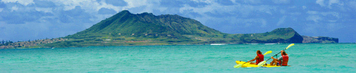 Two Kayakers paddling near mountainous range